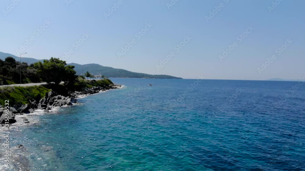 Drone aerial shot of small wooden fishing boat in crystal clear blue waters of Greece coastline. Drone aerial shot of small wooden fishing boat in crystal clear blue waters of Greece coastline.