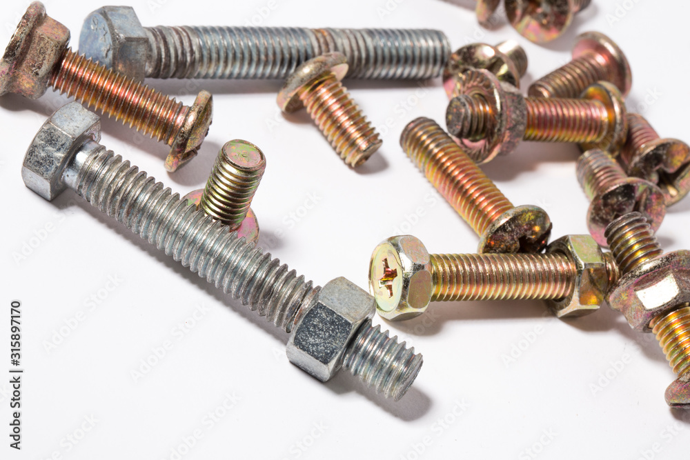 Rusty screw and nuts isolated on white background. Bolts and nuts Rusty screw and nuts isolated on white background. Bolts and nuts