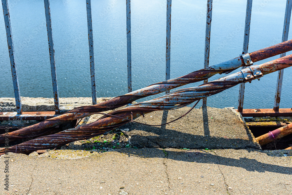 Fototapeta premium Old rusty steel rope of the bridge. Closeup