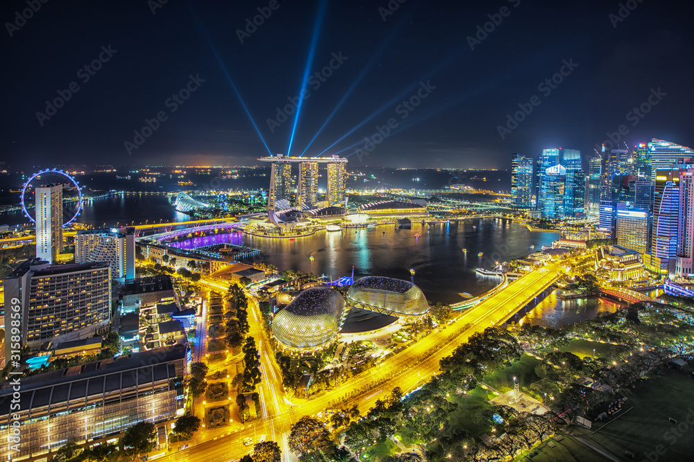 Fototapeta premium Aerial view of Singapore business district and city at night in Singapore, Asia.