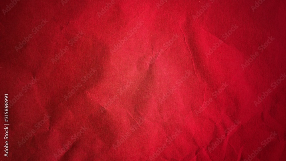 Crumpled red thick paper. Bright beautiful intense blood tint. Texture. Dark  vignetting around the edges of the page. Saturated color. Bulge effect  Stock Photo