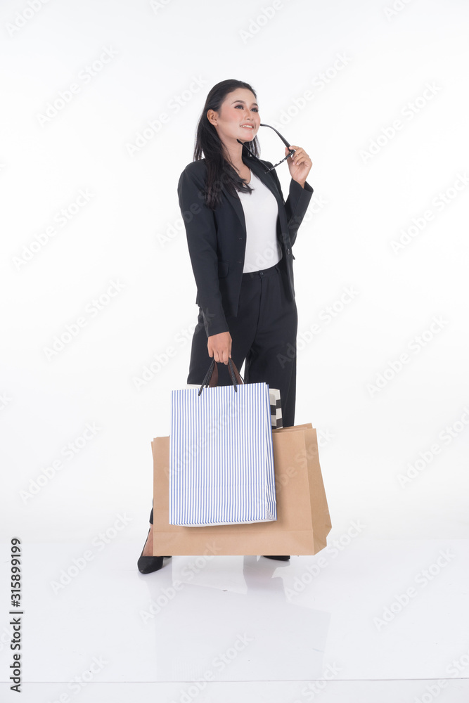 A beautiful Asian woman wearing officewear poses with shopping bags isolated on white background. Full body suitable for image cut out and manipulation works for business and commerce concepts. A beautiful Asian woman wearing officewear poses with shopping bags isolated on white background. Full body suitable for image cut out and manipulation works for business and commerce concepts.