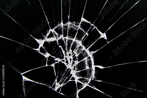 The texture of broken glass with cracks. Cracks on smartphone screen from impact. Concept for design.
