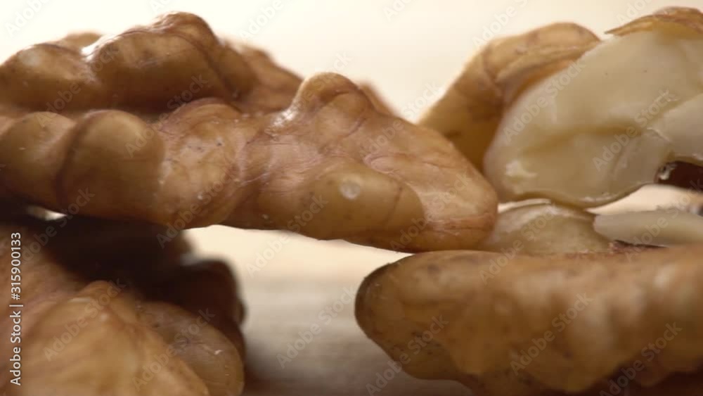 Walnut close up moving . product rich in minerals and vitamins. Walnut turns in a shot. walnut close up lies under beams of the sun. Macro Healthy Super Food Walnut close up moving . product rich in minerals and vitamins. Walnut turns in a shot. walnut close up lies under beams of the sun. Macro Healthy Super Food