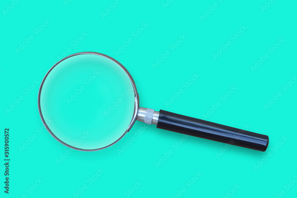 Magnifying glass on blue background. Top view.