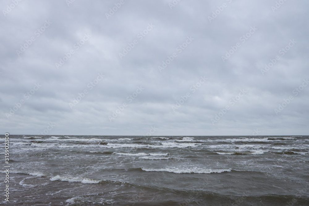 Seaside view of Baltic sea waves on a cloudy and stormy winter day near beach. Seaside view of Baltic sea waves on a cloudy and stormy winter day near beach.