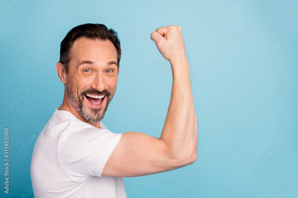 Close-up portrait of his he nice attractive cheerful cheery excited guy showing strong muscles gym effect motivation isolated on bright vivid shine vibrant teal green blue turquoise color background Close-up portrait of his he nice attractive cheerful cheery excited guy showing strong muscles gym effect motivation isolated on bright vivid shine vibrant teal green blue turquoise color background