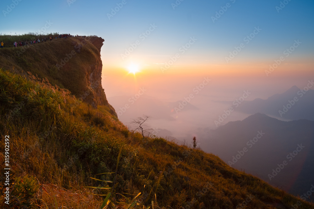 Beautiful landscape in the morning of Phu Chi fa National Park. Chiang Rai Province, Thailand .Sunrise scene with the peak of mountain and cloudscape . Most popular travel destination in Thailand