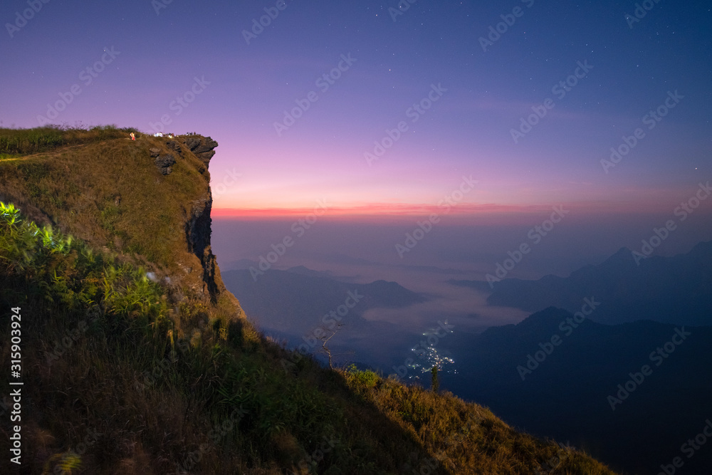 Beautiful landscape in the morning of Phu Chi fa National Park. Chiang Rai Province, Thailand .Sunrise scene with the peak of mountain and cloudscape . Most popular travel destination in Thailand