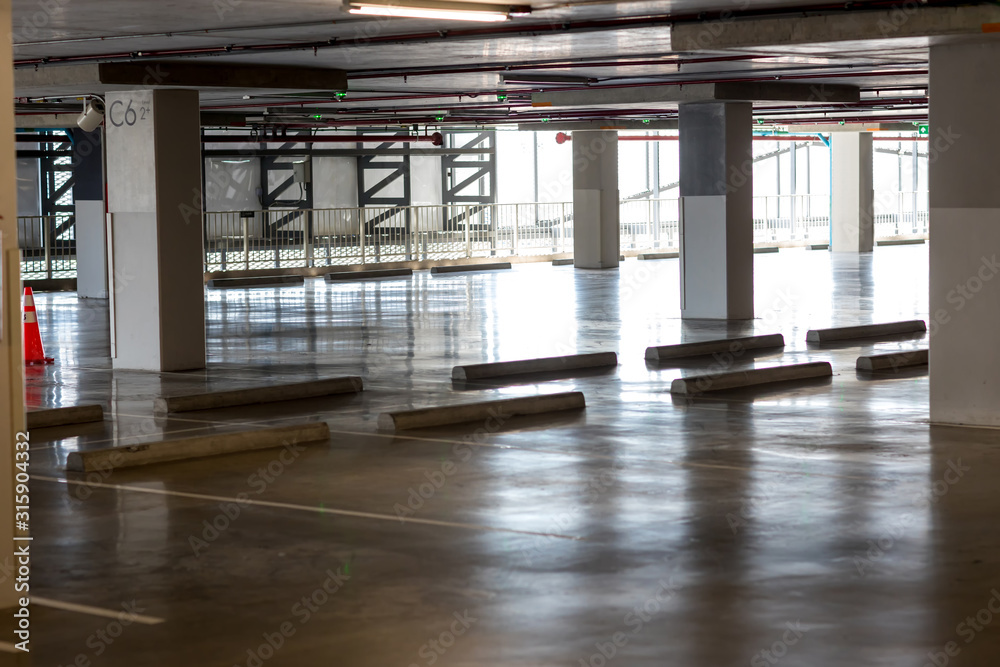 Empty space car park interior at afternoon.Indoor parking lot.interior of parking garage with car and vacant parking lot in parking building.some carpark empty in Condominium or department store.