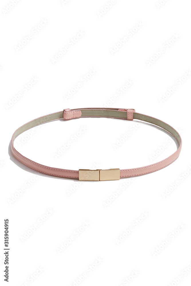 Subject shot of a thin belt made of pale pink patent leather and decorated with a golden buckle made as two right angled parts. The stylish belt is isolated on the white background.