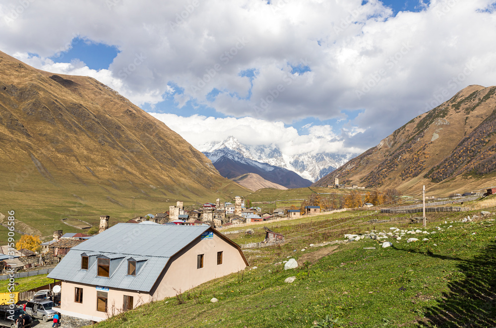Ushguli village on a background of mountains and snow-capped peaks in Svaneti in the mountainous part of Georgia