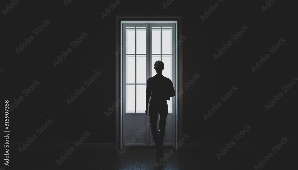 A woman's silhouette in front of the window. Black and white. Concept of loneliness. 3d illustration