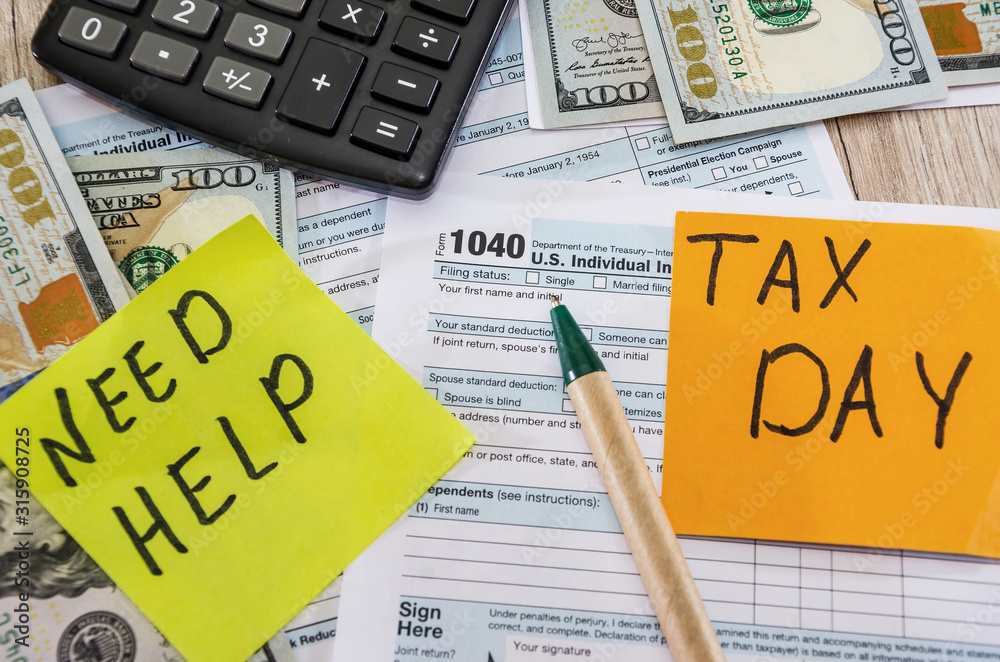 tax forms 1040, calculator, dollars and pen on the table tax forms 1040, calculator, dollars and pen on the table