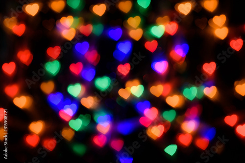 Colored lights in the shape of hearts on a black background