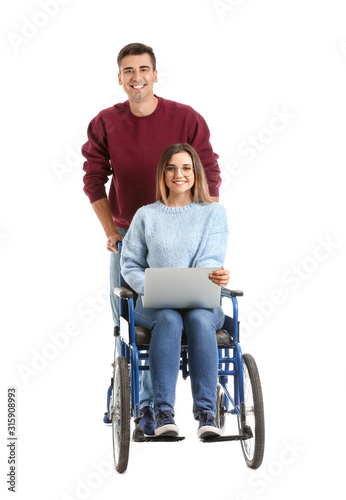 Handicapped young woman with laptop and her husband on white background
