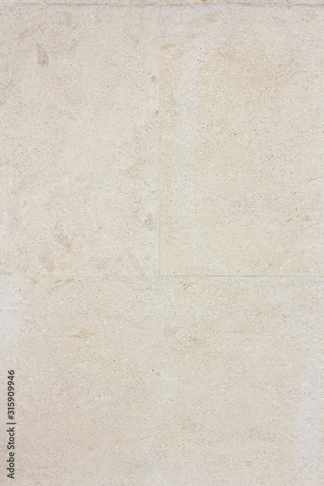 Fototapeta premium light stone wall texture. Space for text. Vertical photo