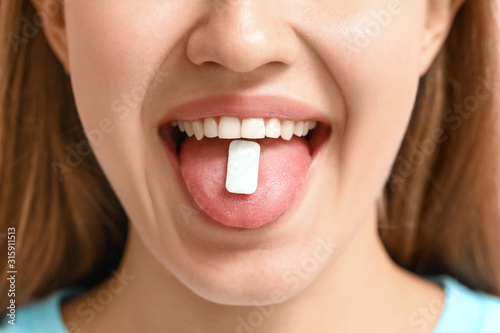 Young woman with chewing gu...