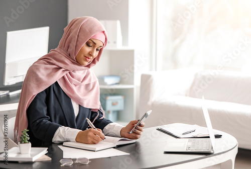 Young Arab woman working in...