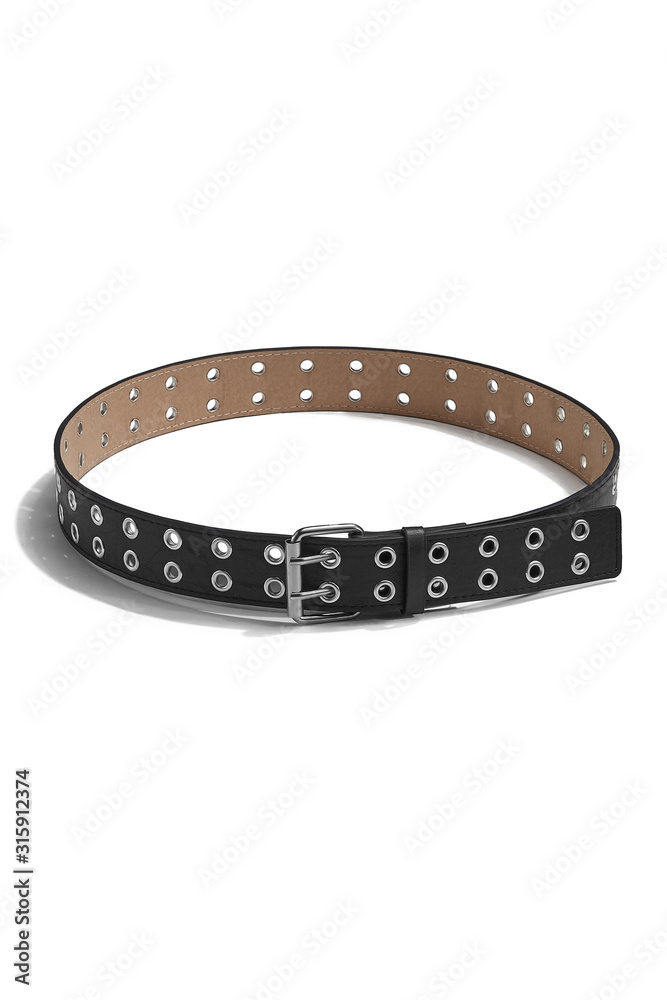 Subject shot of a black leather belt decorated with a steel buckle and double rows of metal eyelet grommets. The stitched belt is isolated on the white background.