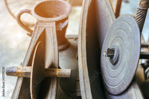 Antique herb roller mill grinding tool and stone grinding wheel with wooden handles .Grinding tool for herbs in store for doctor traditional medical.