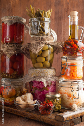 Homemade canned pickled and fermented vegetables for long-term storage.