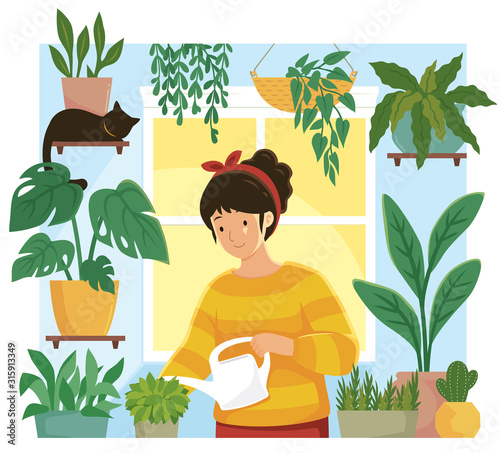 Home garden. Young woman watering plants in flower pots indoors.