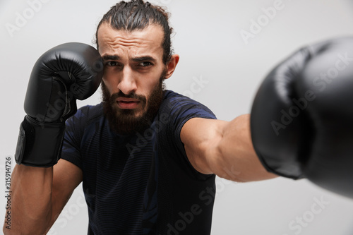 Image of athletic muscular sportsman wearing tracksuit boxing in gloves © Drobot Dean