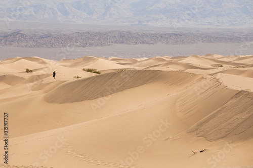 death valley sand dunes of Mesquite Flat  one alone person walk on the ridge