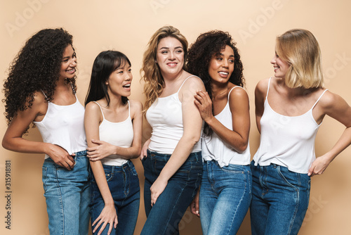 Image of joyful multinational women posing and smiling together