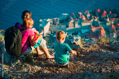 mother with little son and daughter looking at old town Dubrovnik photo