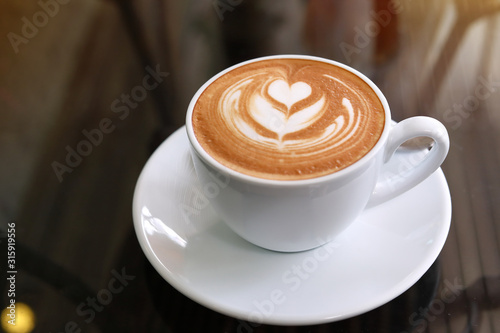 gorącą kawę latte postawioną na stole w kawiarni, wypij śniadanie rano