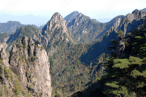 Huangshan Mountain in Anhui Province, China. A beautiful panoramic mountain view of the rocky peaks of Huangshan at White Goose Ridge. From a viewpoint near the summit of Huangshan Mountain, China.