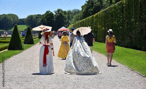 Unidentified people costumed in the fashions of the 17th french aristocracy, walking in French formal gardens. © Tommy Larey
