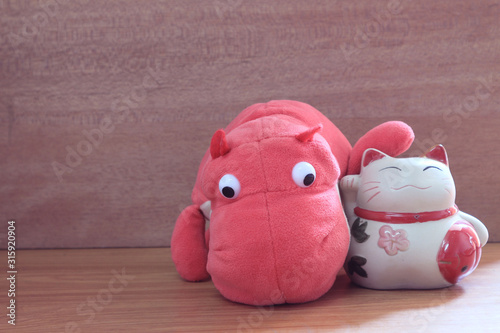 Japanese lucky doll with pink hippo.