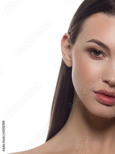 Close-up half face european woman model with classic glamour make-up and nude lipstick. Dark extremely long eyelashes, thiсk eyebrow, evening makeup, dark eyeshadows, natural nude lips with gloss