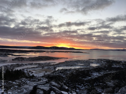 Iceland Winter, orange Sunrise, frozen lakes, snow, sky © Mark