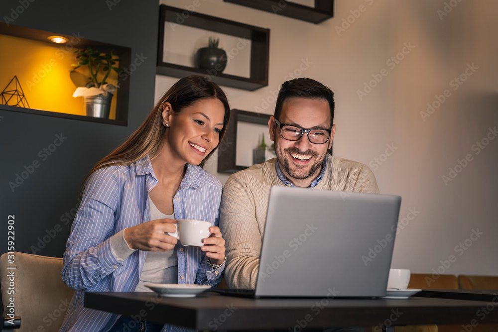 Couple surfing the net on laptop computer Couple surfing the net on laptop computer