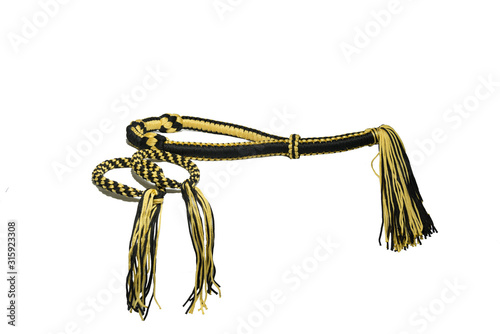 Valokuva Mongkol and Pra Jiad with stripes, yellow black, are isolated on white background, using by Muay Thai athletes, Mongkol is a headband with a long - tailed at the back, Pra Jiad is a type of armband