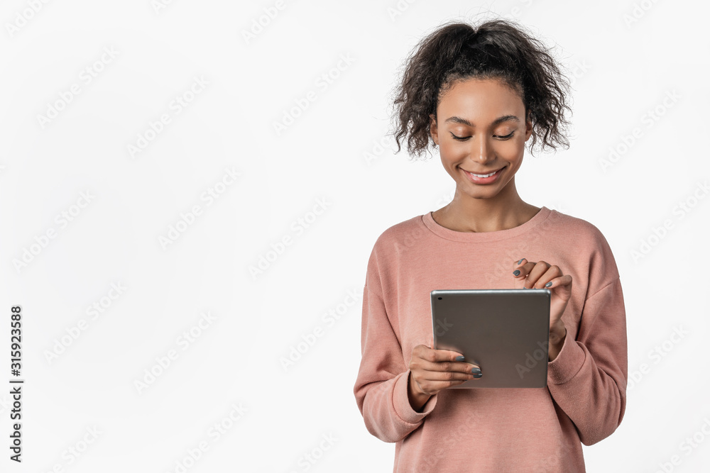 Smiling young woman using tablet computer isolated on white background Smiling young woman using tablet computer isolated on white background