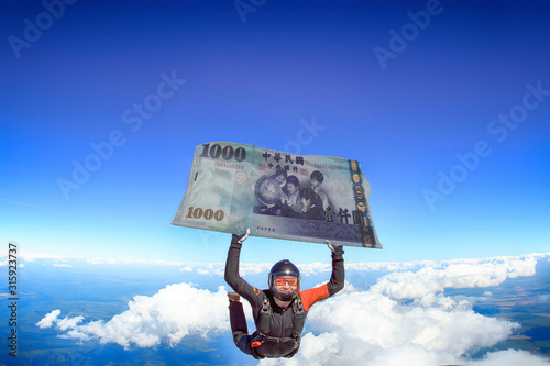 1000 yuan. Parachutist is flying a flag of yuan bill. National investment. Fly men in black suit. 