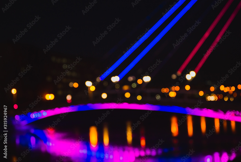 Abstract defocused background of colorful city lights at night.