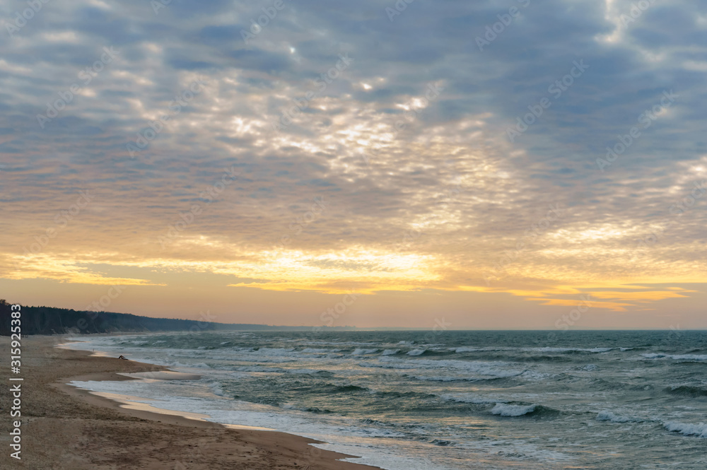 Sunset over the sea. Reflection of sunlight in the sea waves. The sky in the sunset rays. Sunset over the sea. Reflection of sunlight in the sea waves. The sky in the sunset rays.
