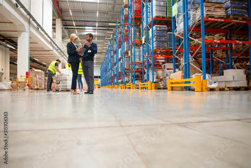 Managers in Warehouse discuss about business strategy