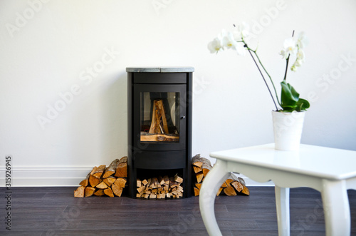 wood stove in modern clean white interior photo