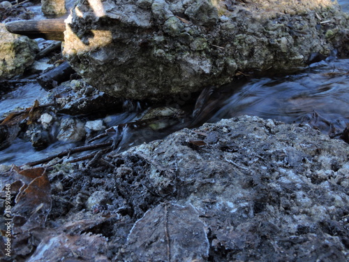 creek between stones, frozen stones