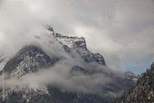 Beautiful fog in the high, rocky mountains in winter.