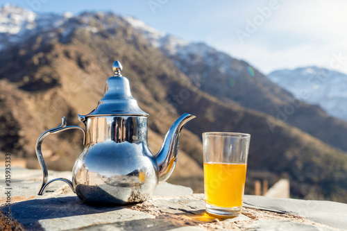Famous Moroccan mint tea and silver kettle in High Atlas mountains © eunikas