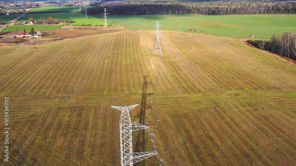 Tower of power lines in the forest. Electric tower line in Landscape ...