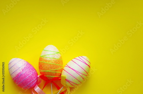 decorative Easter eggs on yellow background